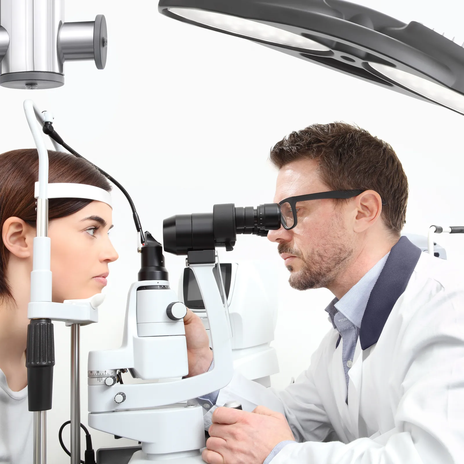 An optometrist examining a patient in the eye exam room